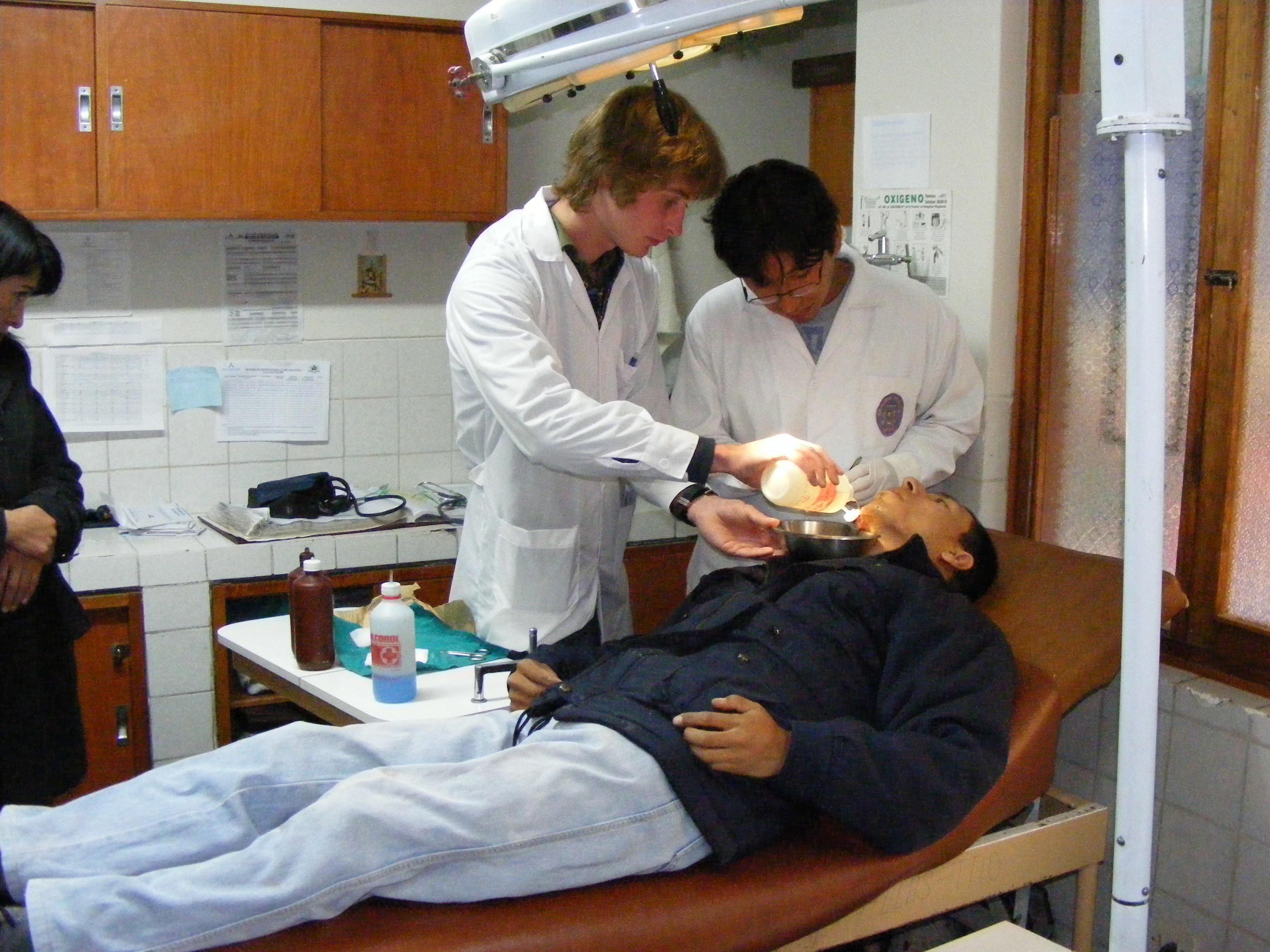 One Projects Abroad intern helping a local doctor in the emergency ward during his medical internship in Peru. A male intern from Projects Abroad is seen assisting a local doctor in an emergency ward during his medical internship in Peru.